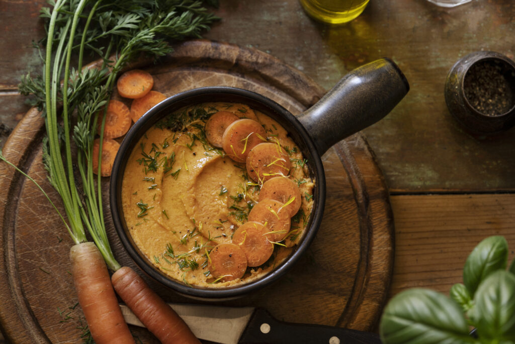 Cozy kitchen scene with a slow cooker full of 10 vegetable soup, emphasizing the ease and convenience of preparing nutritious homemade meals, great for lifestyle and cooking tutorials.