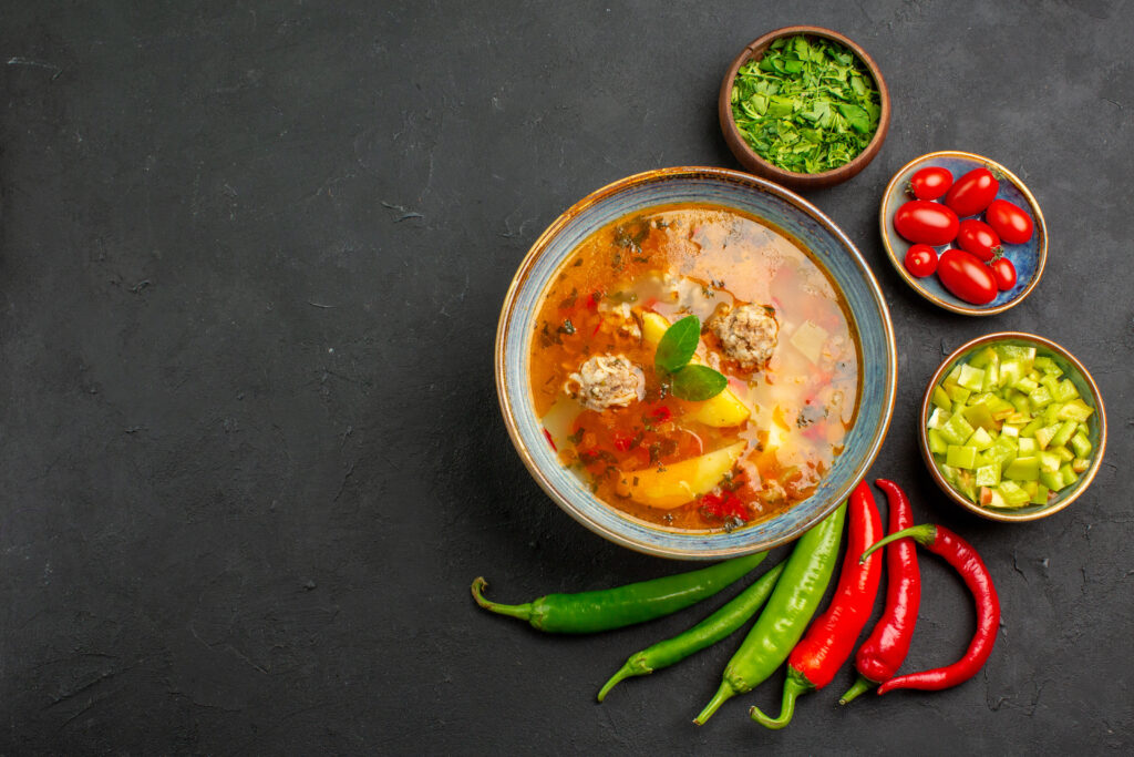 Spicy vegetable soup served in a bowl, featuring a hearty blend of vegetables with a spicy kick, ideal for recipes or articles focusing on warming, flavorful meals.