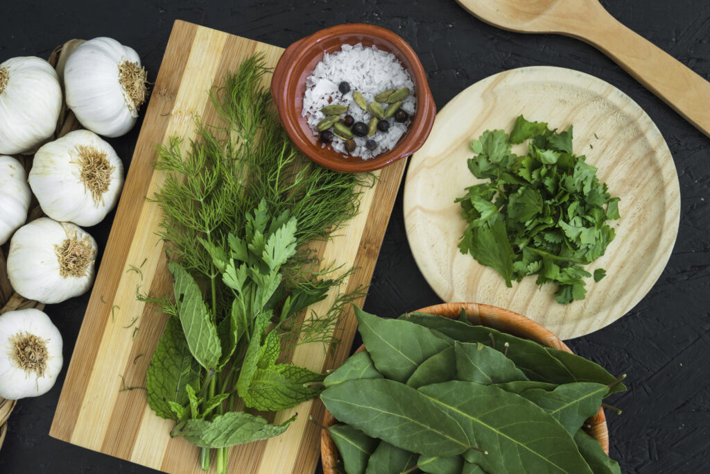 Fresh spinach, sour cream, mayonnaise, and vegetable mix spread on kitchen counter for preparing Knorr spinach dip recipe.