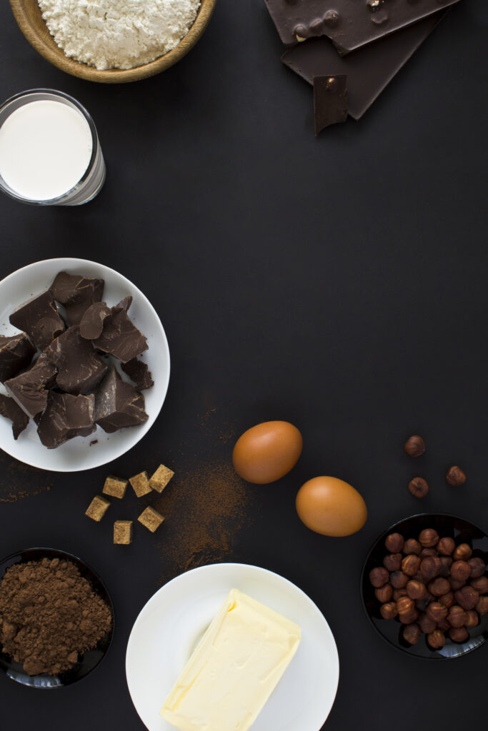 Flat lay of essential fudge ingredients including sugar, milk, butter, and chocolate, showcasing the quality and variety needed for creamy fudge.