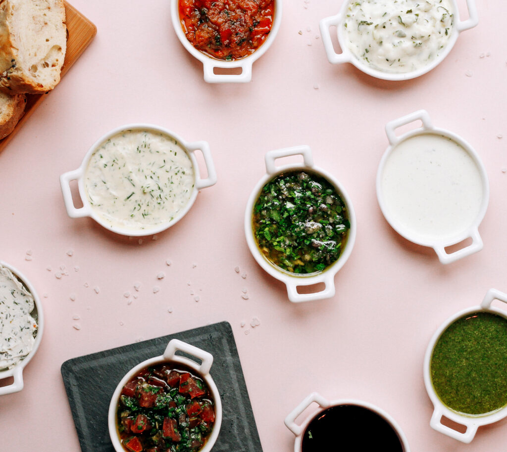 Assorted bowls of Knorr spinach dip variations with different ingredients for customization, including bacon and cheese options.