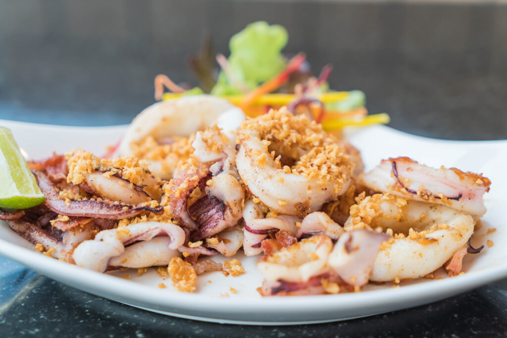 Elegantly presented fried calamari on a plate, capturing the golden crispiness of the dish, perfect for Italian cooking recipes.