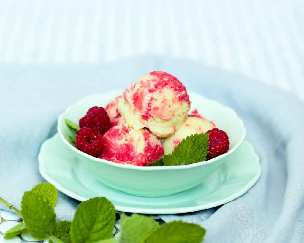 Elegantly served strawberry shortcake ice cream at a garden party, with guests enjoying the dessert in the background.